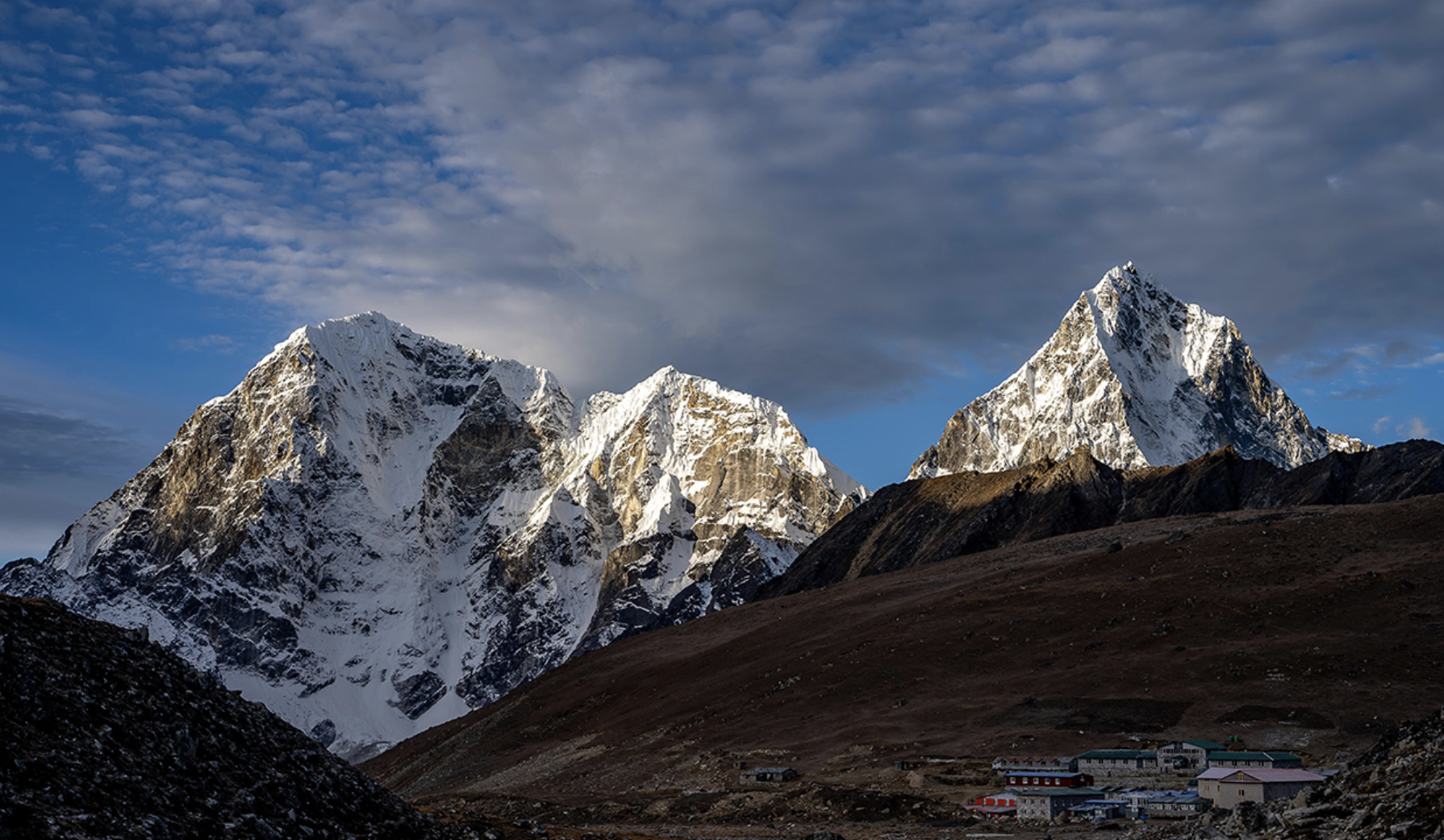 A mountain range with snow on it's sides.