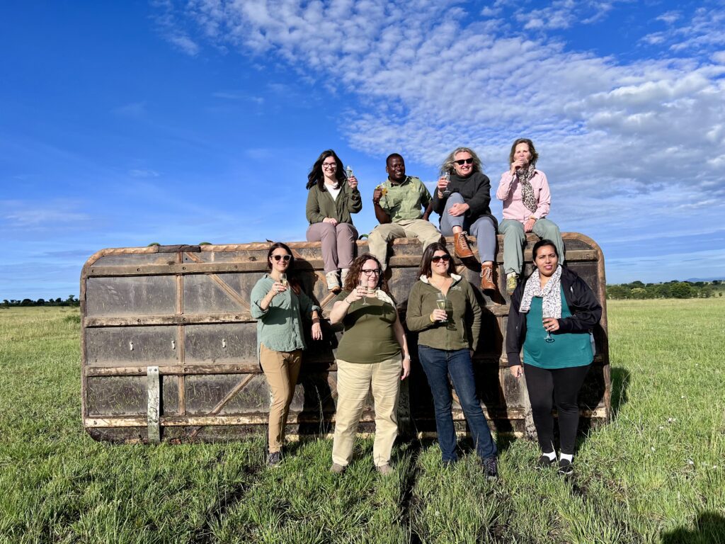 A green and blue clock with the time 1 2 : 3 0.