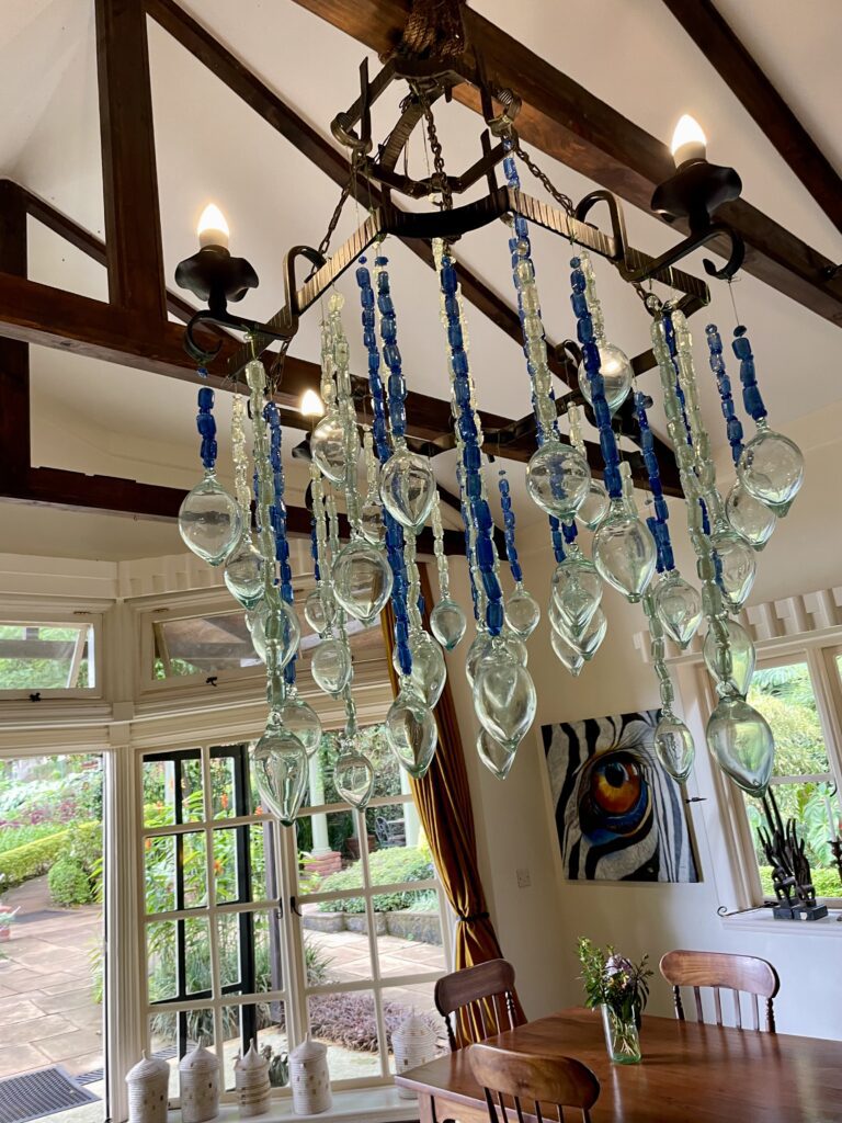 A green and blue clock with the time 1 2 : 3 0.