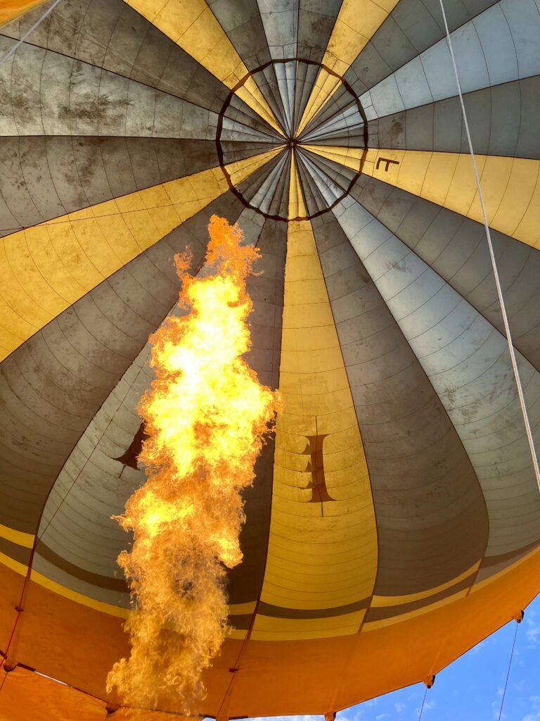 A green and blue clock with the time 1 2 : 3 0.
