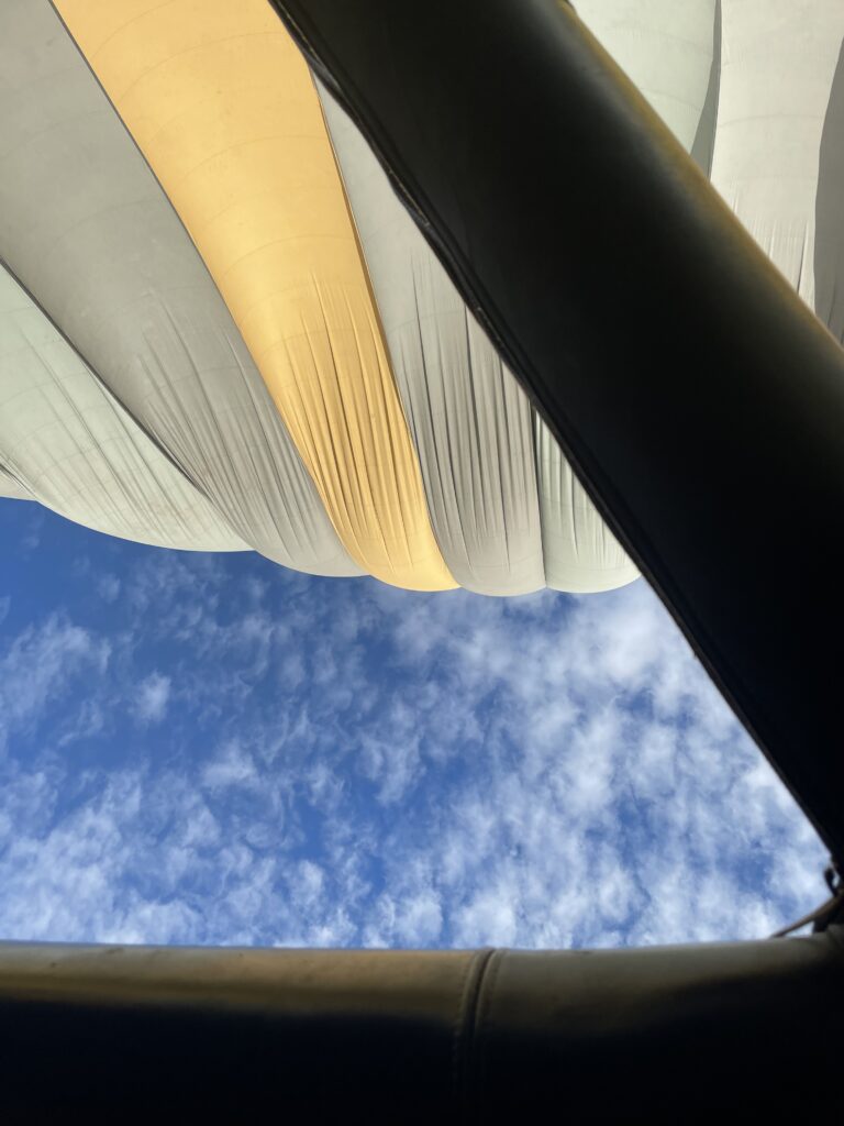 A green and blue clock with the time 1 2 : 3 0.