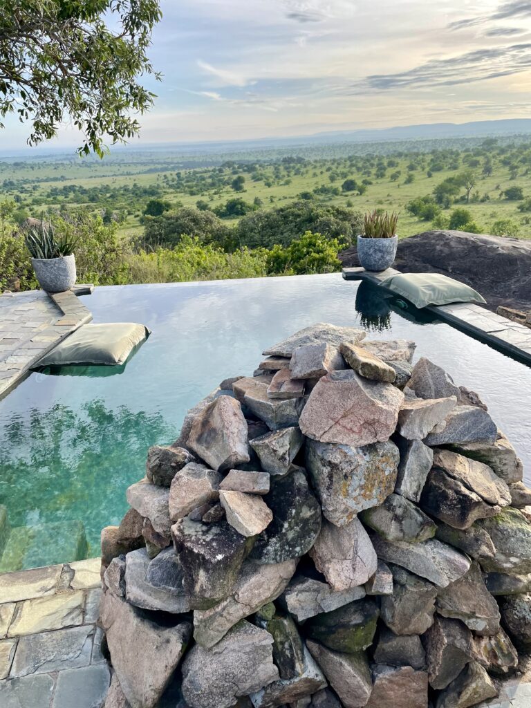 A green and blue clock with the time 1 2 : 3 0.