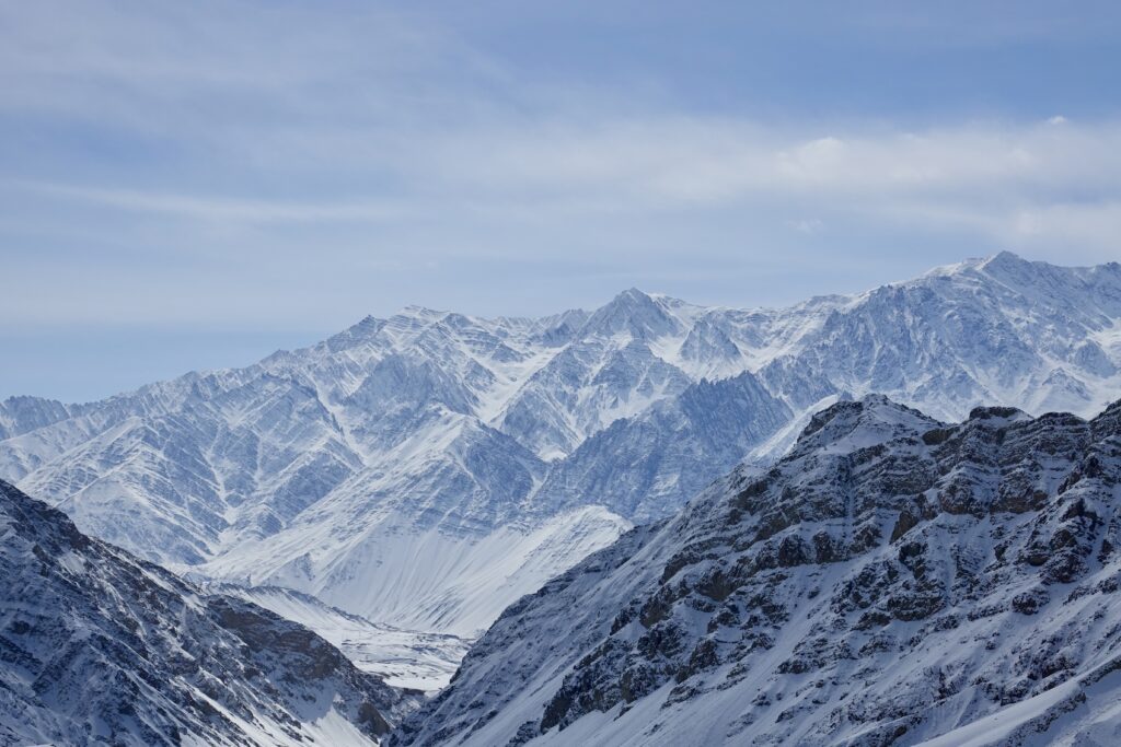 A green and blue clock with the time 1 2 : 3 0.