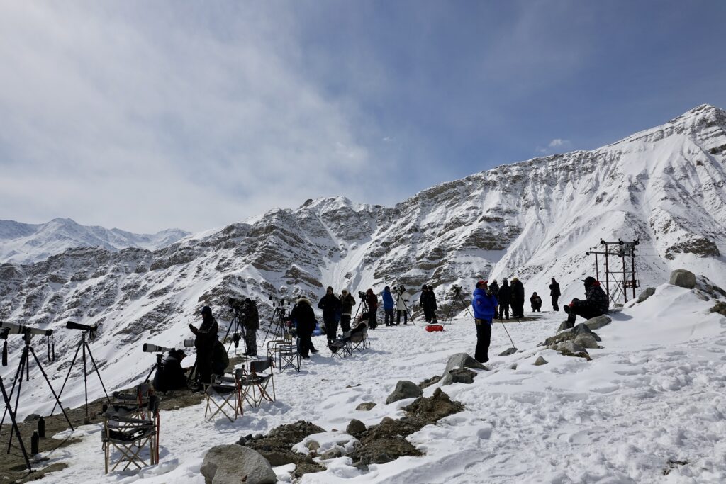 A green and blue clock with the time 1 2 : 3 0.