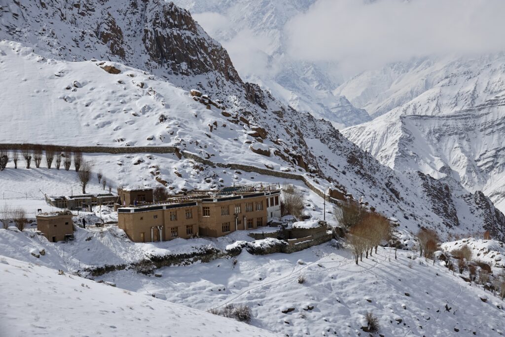 A green and blue clock with the time 1 2 : 3 0.