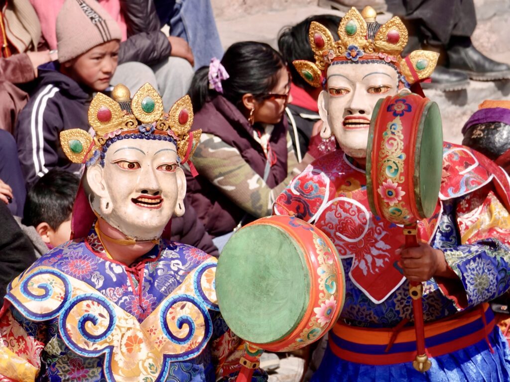 A green and blue clock with the time 1 2 : 3 0.