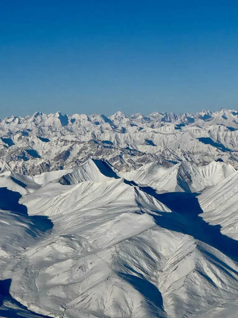 A green and blue clock with the time 1 2 : 3 0.
