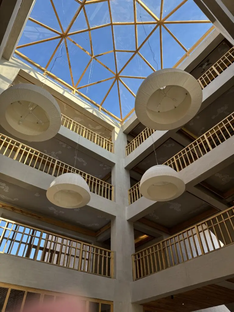 A green and blue clock with the time 1 2 : 3 0.