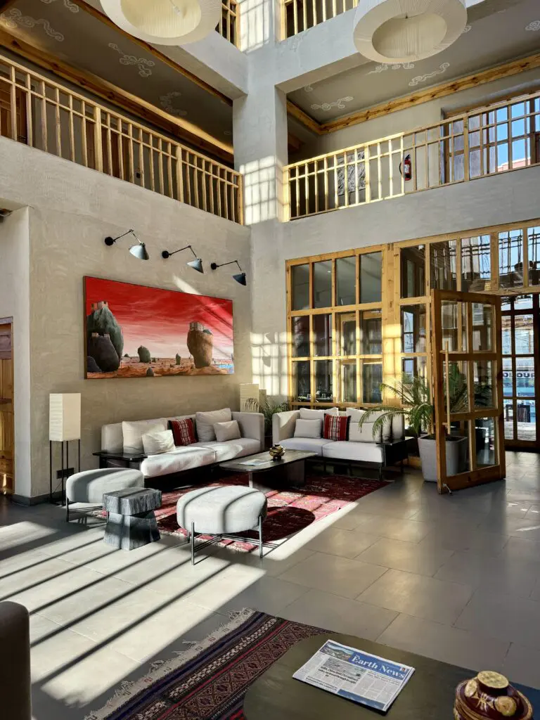 A green and blue clock with the time 1 2 : 3 0.