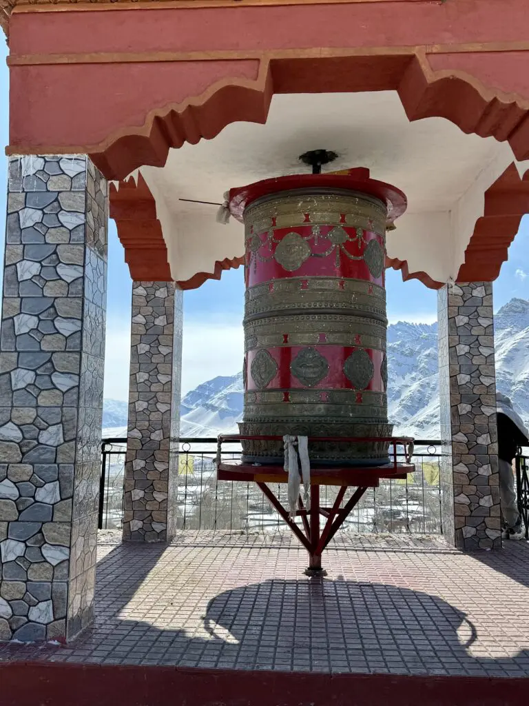 A green and blue clock with the time 1 2 : 3 0.