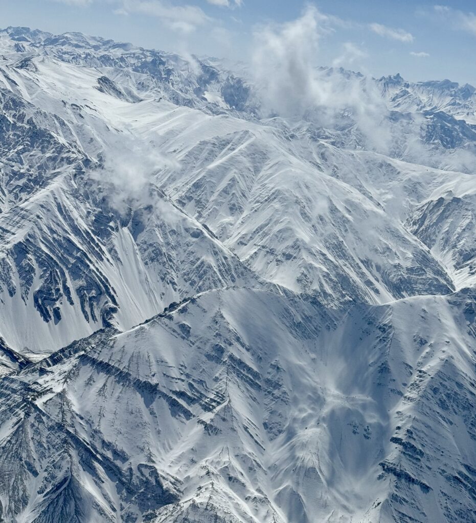 A green and blue clock with the time 1 2 : 3 0.