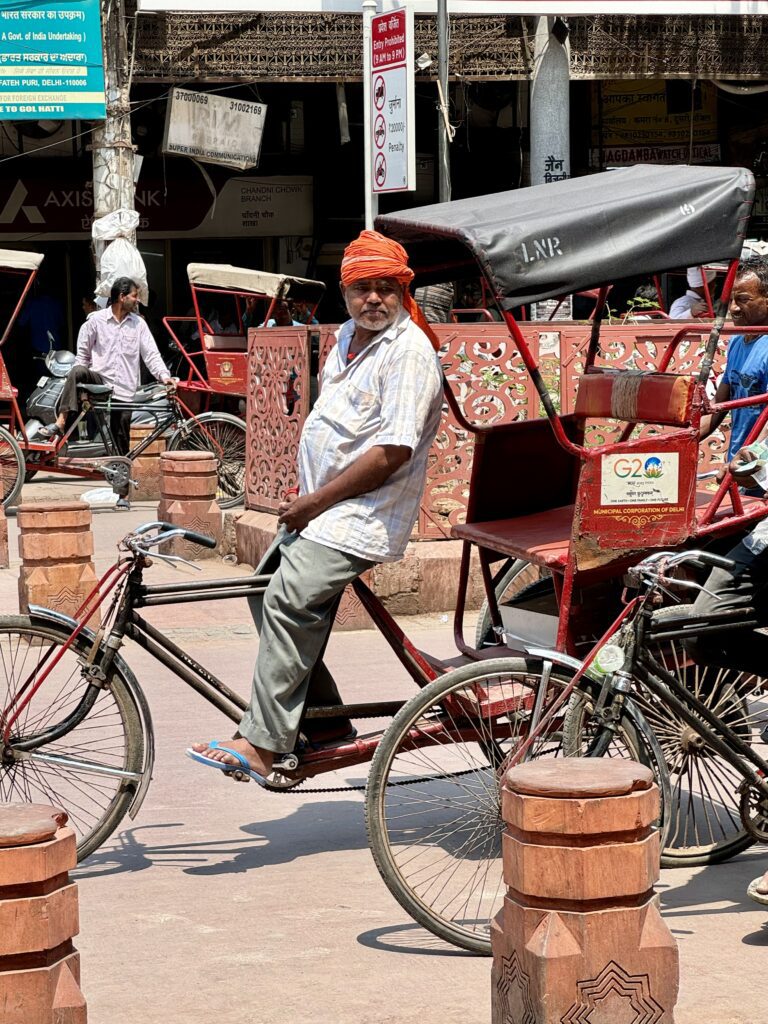 A green and blue clock with the time 1 2 : 3 0.