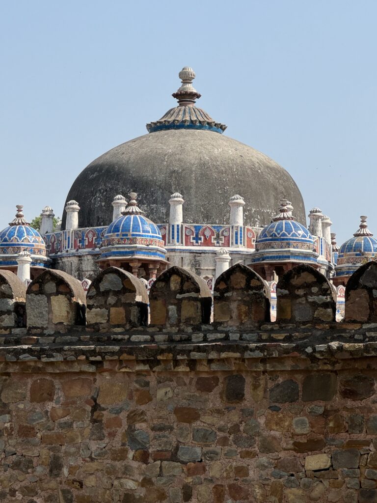 A green and blue clock with the time 1 2 : 3 0.