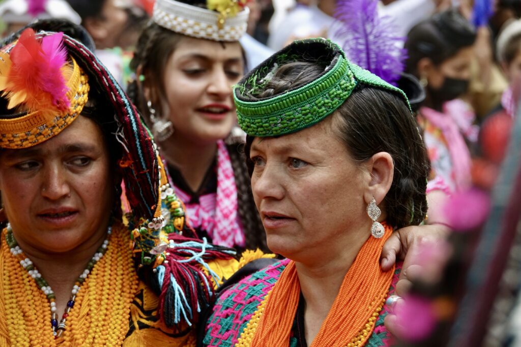 A group of women in colorful clothing and hats.