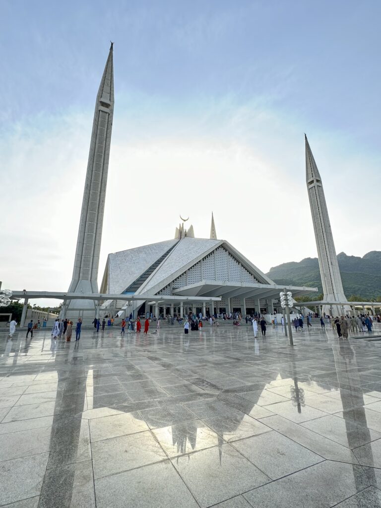A group of people standing around in front of a building.
