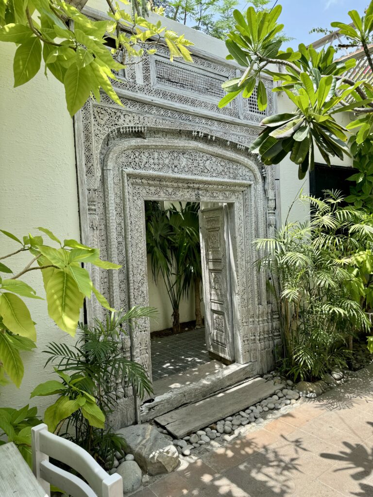 A stone building with plants growing around it.