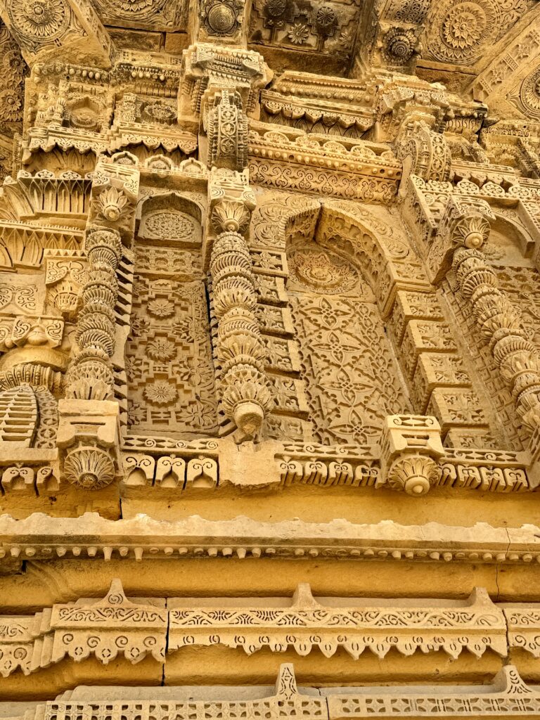 A close up of the intricate carvings on the side of a building.