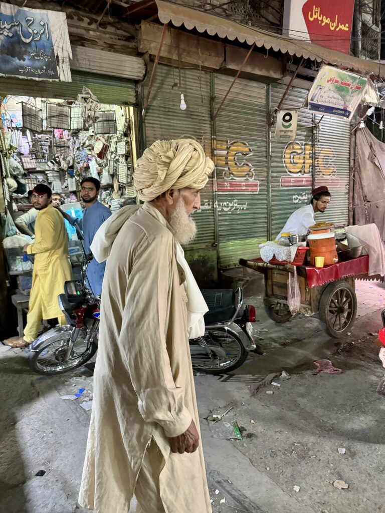 A man in a turban walks down the street.