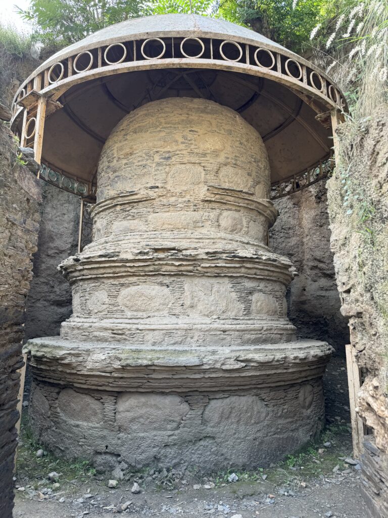 A large stone structure with a dome in the middle.