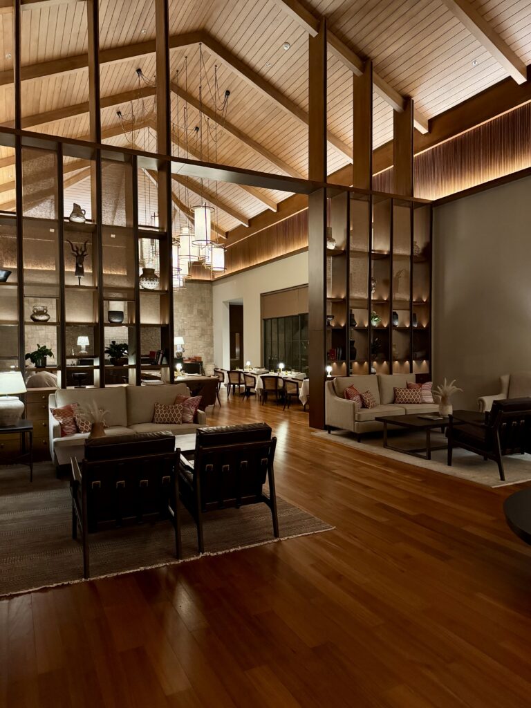 Cozy, stylish living room with wooden beams and warm lighting.