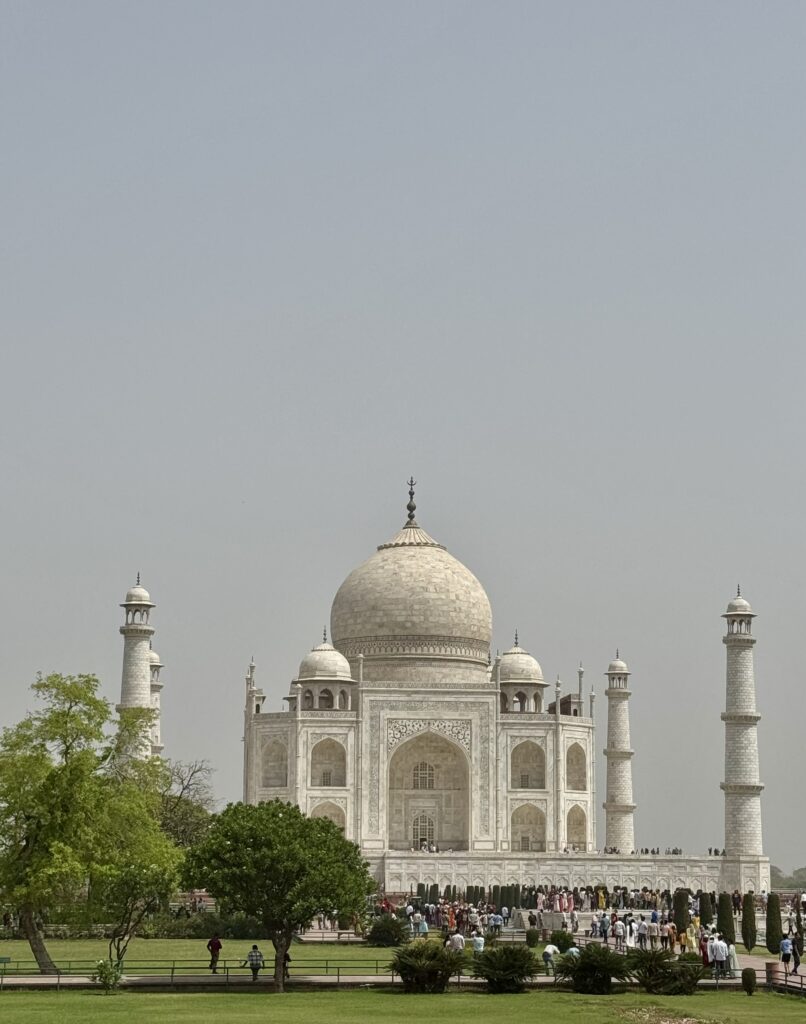 The iconic white marble Taj Mahal against a clear sky.