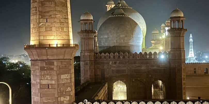 A large brick building with a tall tower in the middle of it.