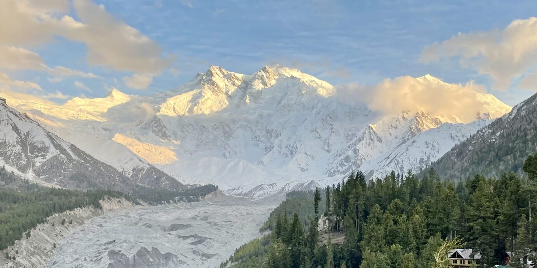 A mountain range with snow on it and trees.